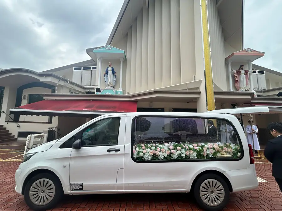 Christian funeral hearse arriving at church