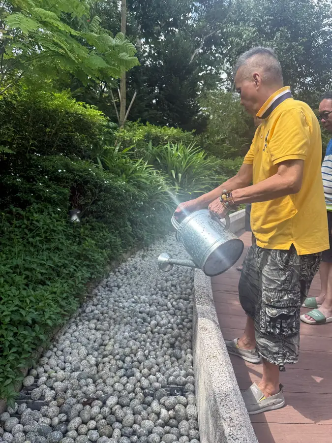 Family scattering ashes at inland memorial garden