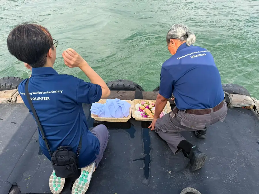 Volunteers performing final prayers at sea