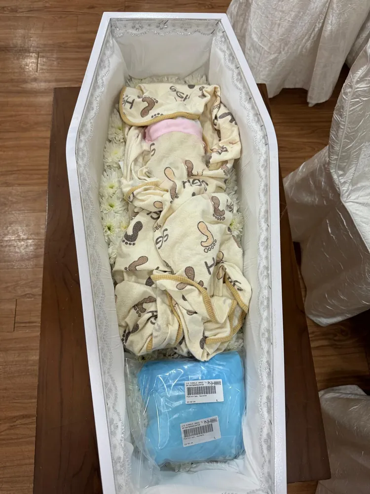 Infant casket with a blanket and keepsakes