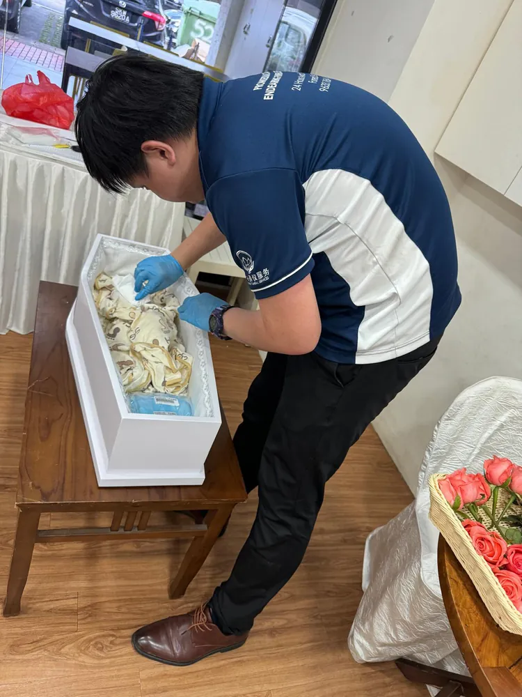 Funeral director preparing an infant casket