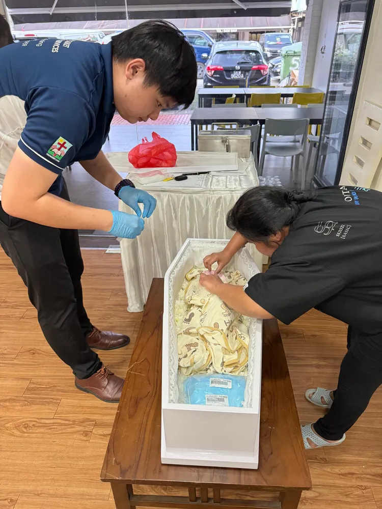 Funeral directors preparing for an infant's final farewell