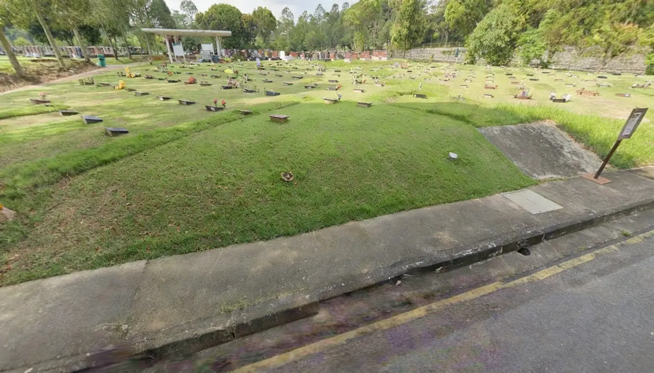 Rows of burial plots with flat grave markers at Choa Chu Kang Cemetery