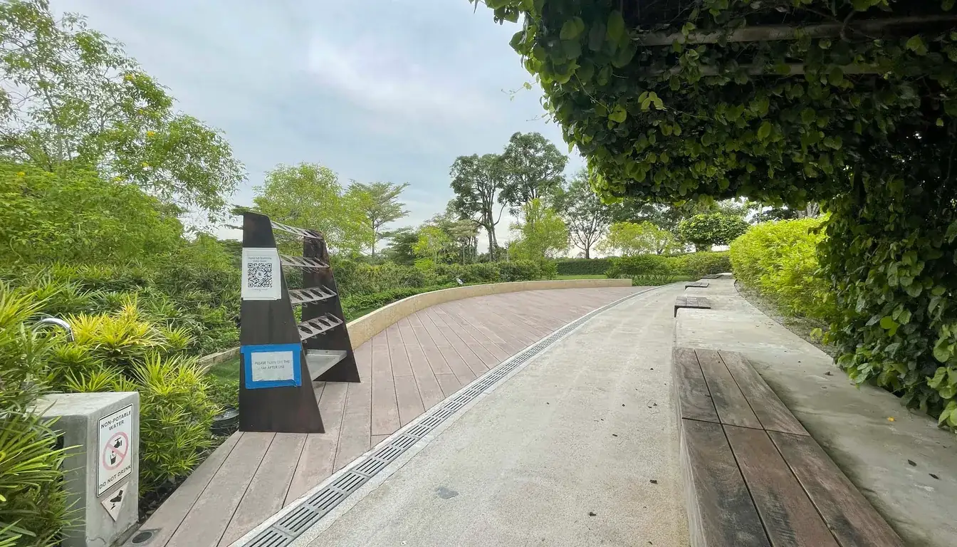 Boardwalk path with ash scattering instructional QR code stand at Garden of Peace